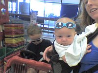 shades  At the market - Sam got his favorite cart (a rocket) and is busy cleaning the dashboard. I like this cart because it actually steers.  You don't run into things!