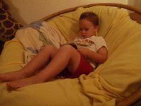 P8100004  Sam doing his "schoolwork" while he waits for me to finish putting Ben in bed. He loves to do his schoolwork (just like daddy) and can't wait to finish up his bath and climb up in his papasan. In fact, here he is during the day doing schoolwork :)