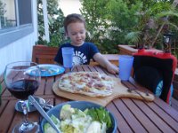 p8210003  Look - mommy grilled pizza while Daddy was gone! Thomas joined us at the table. This is pancetta with some artisan cheese mix over a leftover tablespoon or so of Italian vinaigrette salad dressing. It was good!