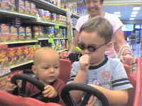 ATT00042  At the commissary! Ben moves his arms right and left like a real driver! Then he studies Sam for technique. Sam is able to use that right hand for anything - thumb, phone, etc.
