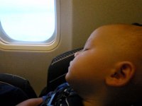 P4140006  Ben had some trouble sleeping in his car seat at first - he couldn't roll over and got really frustrated not finding a comfy position. So guess where he ended up sleeping most of the flight? Yes - snuggled into me. He's such a wild guy that I enjoyed the time with a peaceful, calm Ben in my arms. Sam was leaning on my left shoulder the whole time. Close to arrival I was able to put Ben in his seat and buckle him up. He slept right through landing even with the bumps and loud noise!