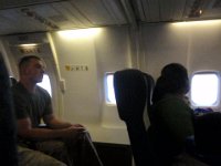 P4140010  The mom across the aisle was meeting her husband in CA midway through his deployment. She'd been waiting in the terminal for 20 hrs trying to catch a flight to the west coast. I feel very fortunate we managed to get on this plane. The only reason I was able to make my way east was due to some fortuitous detective work - I figured out the tail number of this plane (from HI to CA) was the same as the tail # of a plane going from CA to VA. When I travel alone without Dave, I need a special letter from the command, and I can only go point to point, I can't get off at a hub and find a connection. BUT if I fly on a plane with a continuing mission, same tail # (same aircraft) I can stay on the plane. They said I'd have to get off, pull my baggage to make sure it would stay on the plane (they don't sort baggage, and you don't get assigned seats), then recompete for seats in San Diego. I had already called and knew the supervisor of the terminal so when I saw a guy heading to the plane with baggage tags, I figured it was my buddy. He said I'd be fine and not to worry. He took care of us and we made it all the way through to Norfolk just fine.