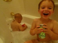 P4180025  Funny funny bath time. Sausage-heads are still thirsty. Actually, Sam was in doing #2 and hollered out to me "MOOOOM! Bring the sparkle-ling water, puhleease!" So he had it on the sink next to him while he lingered over his production. Then I thought Ben might want some, too. They both enjoyed dumping their drinks in the bath water.