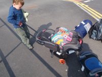 P4260375  On the move again. See Dave's latest gear purchase, the wheels which attach to the car seat, turning it into a stroller or cart? Love it.