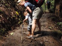 2010-03-23MaunawiliDemoAndFalls (42)  Mom caught one of my rare smiles on this leg of the trip. By now I'm hungry because the boys have eaten all my food (and I forced Gramma to have a few crackers along the way). Note to self - pack even more food and make it easily reachable! There was no place to sit down and snack and evaluate options, like putting Ben back in the pack. ("yick yick yick!" Gramma would say!)