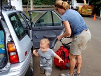 2010-03-23MaunawiliDemoAndFalls (50)  Loading up the car. Richard is tired of mosquitoes trying to force their way into the car while he waited! Gramma wrapped Sam up so he didn't get mud all over. Thankfully the mud has an affinity for skin and not much else. It does not come off easily!!! That was fun - much more fun after a beer over dinner and retelling all the stories :) See my write-up on www.kampkrug.com (3/23/10) for some anecdotes. Sam really made some kids laugh :)