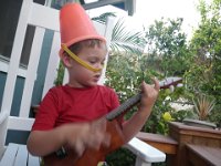 IMGP1775  We were really looney tunes this night...Sam put on this hat (since in one of Eddie Kamae's songs "Golden Stallion" - written by Rev Kamakahi but sung by Eddie in our version) it talks of a boy with a pail for a helmet and a pillow for a shield.