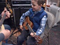Pic-12192013-001  Ben is now taking lessons with Randy Parris, and using the ukulele Eddie Kamae gave to Sam when he noticed that Sam's little uke had been really worked hard in all his jamming. We are so lucky, and have such wonderful memories of Hawaii and the Kamaes whenever the kids play this uke.