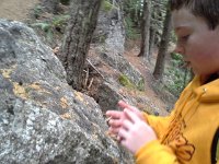 20151024 121318  These rocks seem to have fallen from the ledges you'll see later. Sam says there's calcite in the rocks. He's testing them.